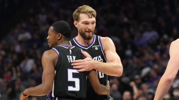 Dec 14, 2023; Sacramento, California, USA; Sacramento Kings guard De'Aaron Fox (5) is congratulated by forward Domantas Sabonis (10) after a basket against the Oklahoma City Thunder during the second quarter at Golden 1 Center. Mandatory Credit: Darren Yamashita-USA TODAY Sports